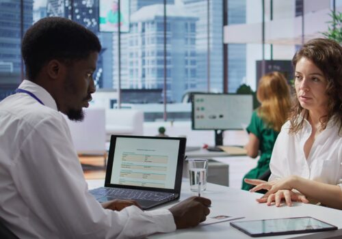 Staff interviewing woman applicant job seeker in high end office